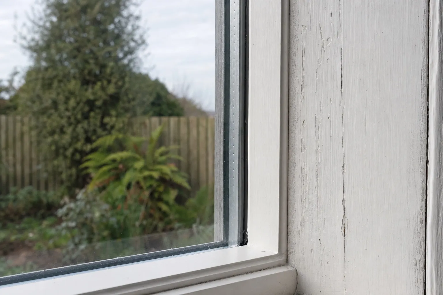 Illustrative: a new painted timber bead holding a sealed double-glazed unit in an old sash