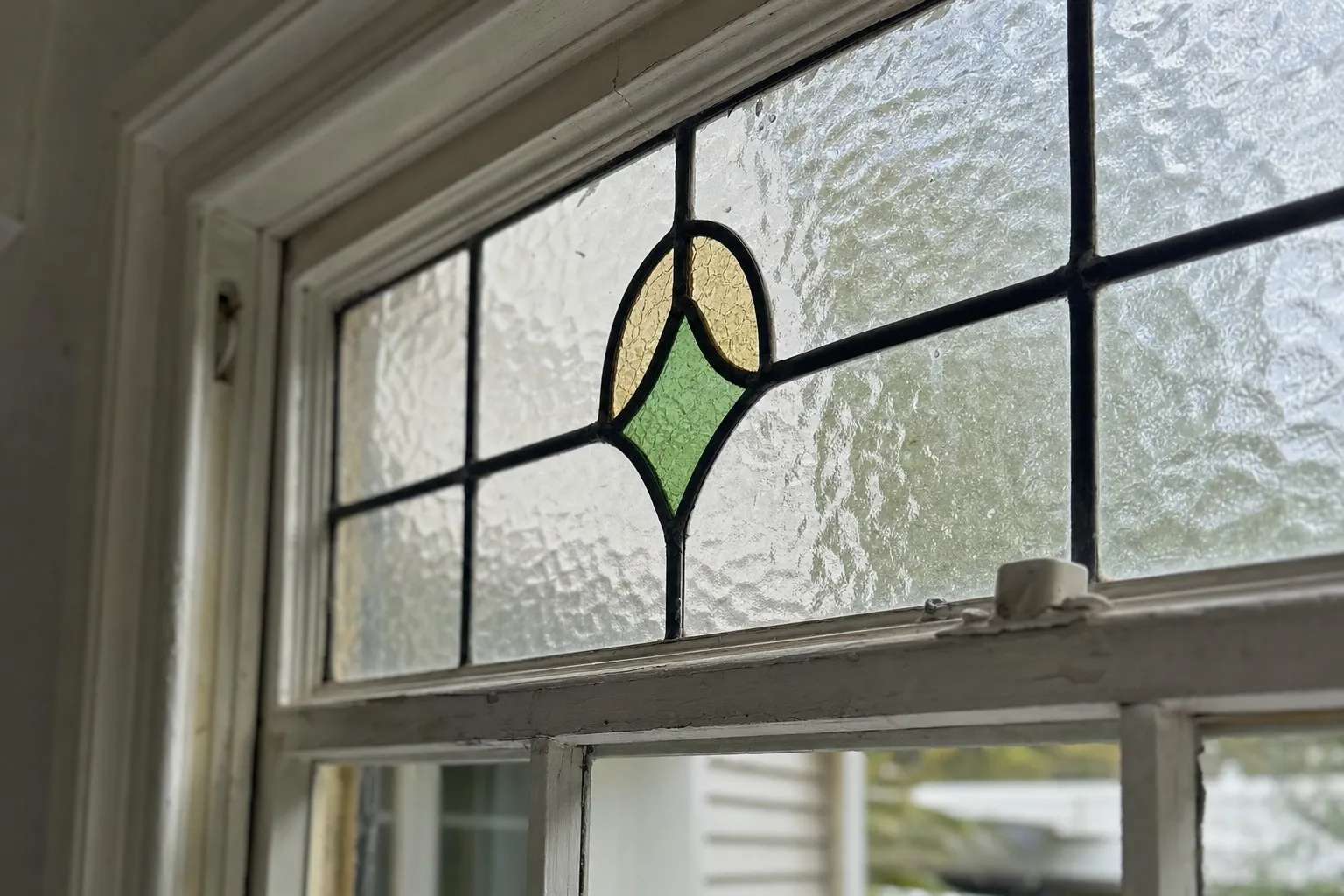 Illustrative: a leadlight panel in the top sash of a villa window